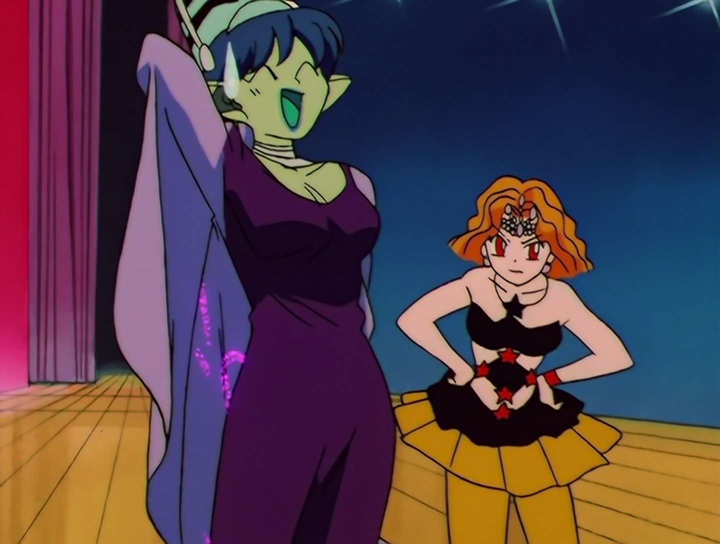 U-Tahime is laughing with that “Hand behind the head” pose that anime characters have when they’re a bit embarrassed. Mimete is nearby looking annoyed.